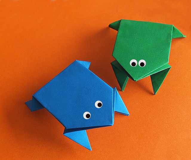 two origami frogs meeting